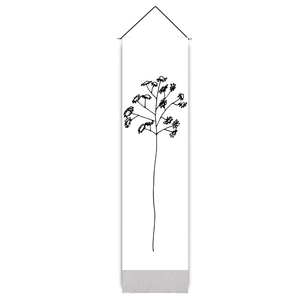 Close-up of minimalist botanical branch tapestry with black wooden hanger and rope