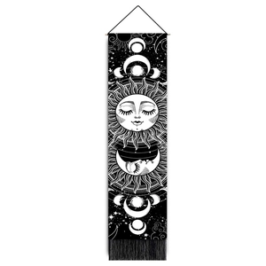 Detail of sun and moon phases tapestry with mystic celestial art and black fringe