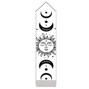 Detail of bohemian sun and moon phases tapestry with high-contrast black celestial art