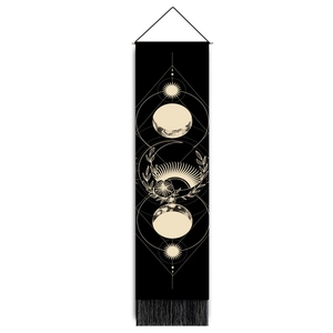 Vertical black tapestry with moon phases, sun motif, wooden rod and bottom tassels