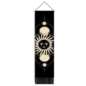 Detailed view of sun and moon phases tapestry with elegant black tassels and wood pole