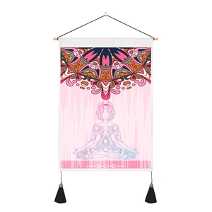 Close-up of Nordic yoga tapestry with pink mandala print and decorative black tassels