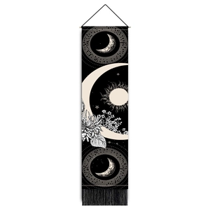 Detail view of Bohemian sun and moon tapestry with celestial patterns and black tassels
