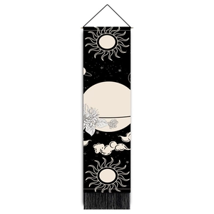 Vertical black tarot tapestry featuring sun and planet prints with wood pole and tassels