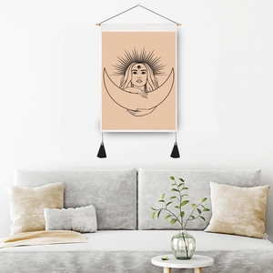 Bohemian wall tapestry with line art moon goddess and tassels in a modern living room