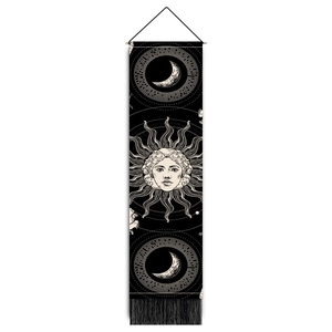 Detail of bohemian mandala tapestry featuring sun, moon, stars, and black tassels