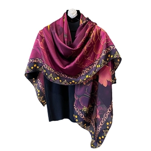Elegant 110cm magenta silk scarf with floral and baroque patterns draped on a mannequin