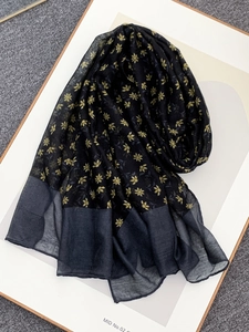 Detail view of floral voile scarf with yellow blossoms and sheer contrast borders