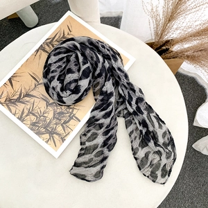 Detail of lightweight leopard print square scarf with delicate texture and soft drapery