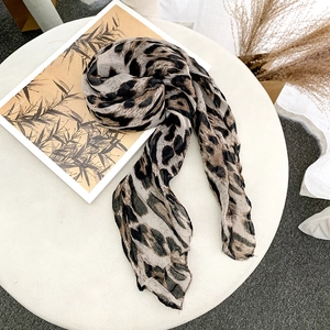 Detail of soft leopard print chiffon scarf showing lightweight texture and leopard pattern