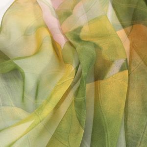 Macro shot of lightweight georgette scarf showing lotus pattern and sheer fabric texture