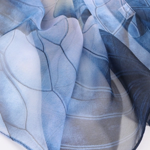 Close-up of lightweight blue lotus georgette silk scarf showing fine machine-rolled edges