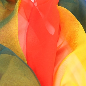 Close-up of lightweight georgette scarf fabric showing vibrant gradient colors and texture