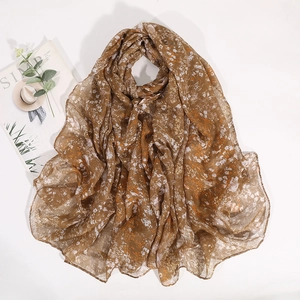 Detailed flat lay of floral brown cotton scarf with soft pleats and a vintage pattern