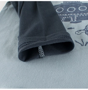 Close-up of double-stitched cuff on a cotton long sleeve tee with ocean prints