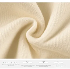 Close-up of soft beige ribbed knit fabric showing texture and textile safety standards