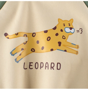 Detail view of cotton fleece sweatshirt featuring a yellow leopard print and LEOPARD text