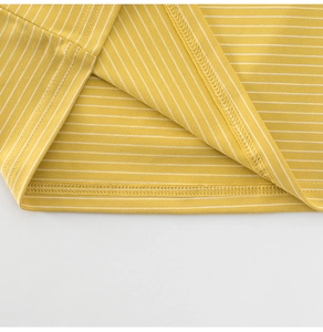 Detailed view of the double-stitched hem and yellow striped knit fabric on a child's tee
