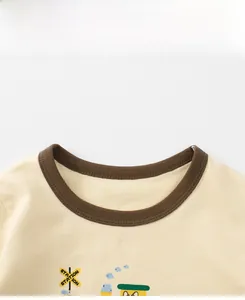 Detail of contrast brown crew neck and soft cotton knit fabric on kids graphic t-shirt