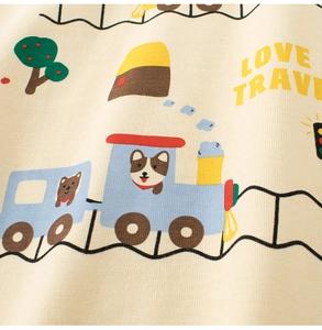 Detail of beige knit kids T-shirt with blue train print and Love Travel text
