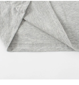 Detail of grey knitted cotton fabric with ribbed texture and double-needle hem stitching