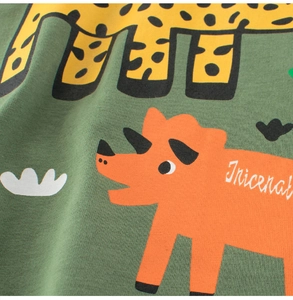 Close-up of soft cotton kids T-shirt fabric featuring a cartoon triceratops print