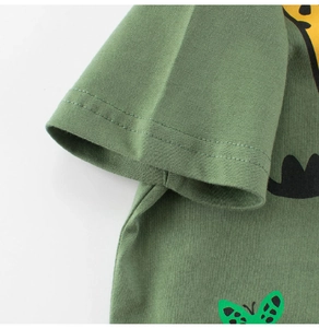 Close-up of green cotton kids T-shirt showing double-stitched sleeves and knit texture