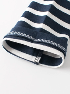 Close-up of blue and white striped long-sleeve cotton T-shirt cuff with neat stitching
