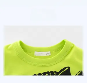 Detail of a bright green kids' cotton T-shirt neckline with ribbed finish and size label