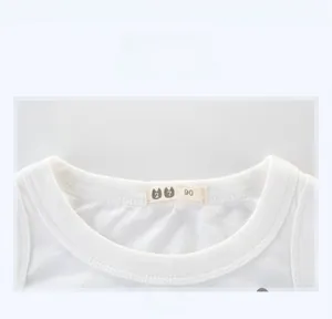 Close-up of ribbed neckline and size tag on white cotton children sleeveless top