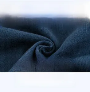 Close-up of dark blue knit fabric showing fine mesh texture and breathable cotton quality