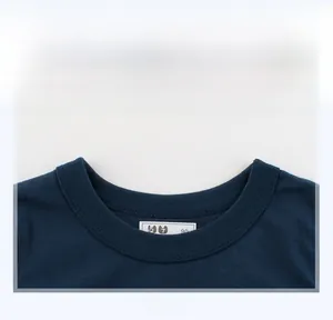 Detailed view of the ribbed neckline and size tag on a navy blue short-sleeve boy's T-shirt