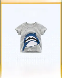 Detail of grey cotton kid's T-shirt featuring a blue cartoon great white shark print