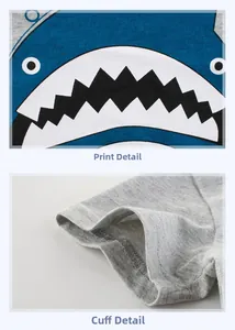 Detail view of cartoon shark print and fine double-needle stitching on gray cotton kids T-shirt