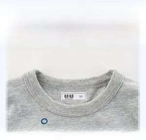 Close-up of the ribbed crew neck and neat stitching on this grey cotton kids t-shirt
