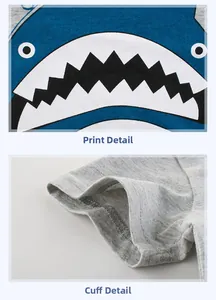 Detail of cartoon shark print and double-needle stitching on grey cotton kids T-shirt