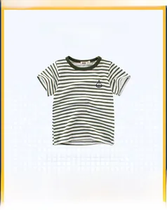 Detail of green and white striped cotton kids T-shirt with a small boat print on chest