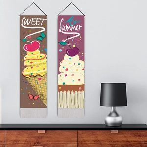 Sweet Christmas ice cream and cupcake wall tapestries with tassels hanging on a white wall
