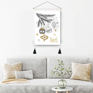 Christmas Noel wall tapestry with pine branch and golden ornaments hanging above a sofa