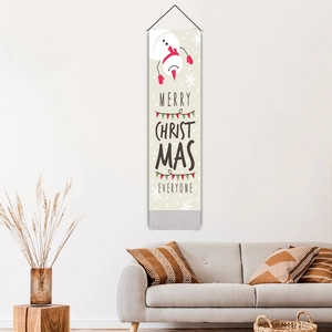Christmas snowman wall hanging banner with tassels and black rope over a cozy sofa