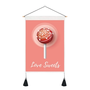 Detail of pink wall tapestry with Love Sweets candy print and black tassels