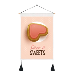 Detail of pink heart dessert wall hanging with wooden rod and black tassels