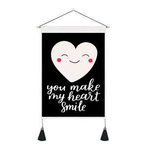 Detail of black tapestry featuring a smiling heart and you make my heart smile text