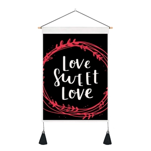 Detail of wall tapestry featuring Love Sweet Love text and black tassel fringe