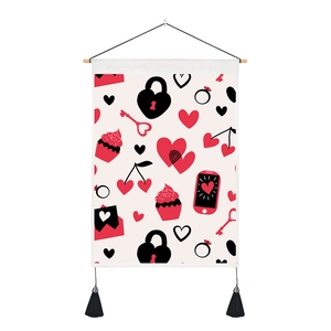 Close-up of heart-themed tapestry featuring a wooden rod, black tassels and cute prints