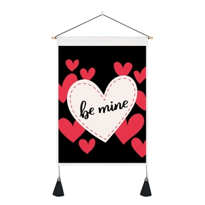 Close-up of heart print wall banner with be mine text, wooden rod and black tassels