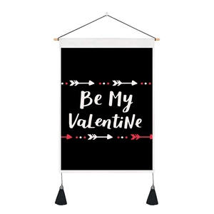 Detail of Be My Valentine black tapestry with wooden hanging rod and bottom tassels