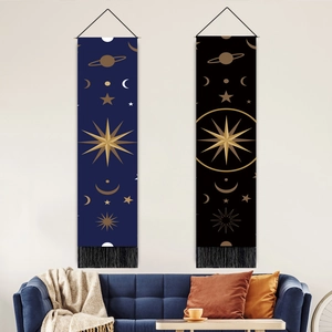 Modern celestial wall tapestry with gold stars and moon patterns, fringe hem, and wood pole