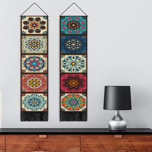 Vertical Nordic Mandala wall tapestries with tassels hanging on a clean white wall