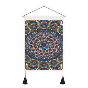 Detail of bohemian mandala tapestry with wooden bar, hanging rope and black tassels